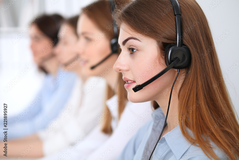 © rogerphoto - Call center. Beautiful cheerful smiling operator consulting clients with headset. Business concept of customer service © rogerphoto - Call center. Beautiful cheerful smiling operator consulting clients with headset. Business concept of customer service