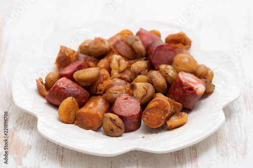 portuguese smoked sausages with chestnuts on white dish