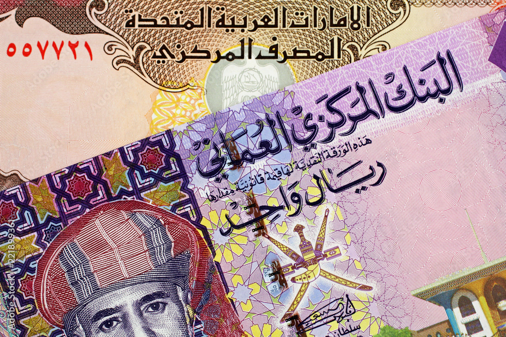 Fototapeta premium A close up image of an Omani one rial note with a United Arab Emirates five Dirham bill