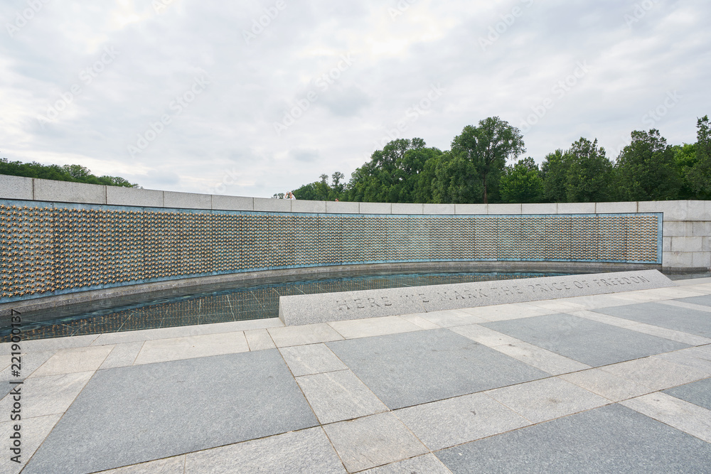 The Freedom Wall is on the west side of the memorial, with a view of the Reflecting Pool and Lincoln Memorial behind it. The wall has 4,048 gold stars, each representing 100 Americans who died in the 