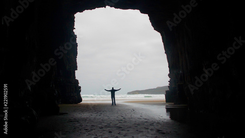man in cave opening