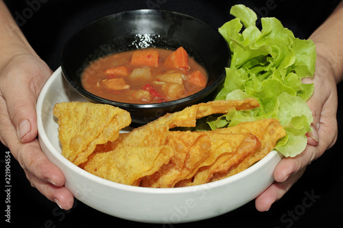 Crisy wonton with Japanese yellow curry topped green oak. photo