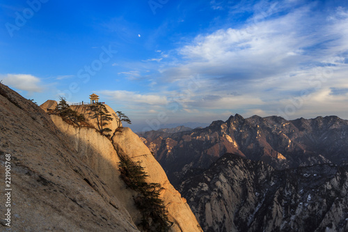 Huashan Sunset, Mount Hua - Huayin, near Xi'an in Shaanxi Province China. Chess Playing Pavilion, Pagoda at the top of a Cliff with Steep Vertical Drop-off, Famous yellow granite mountains of China.