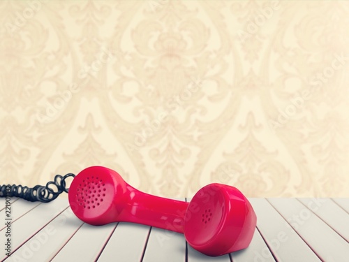 Red telephone receiver  on  background