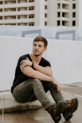 Young Fit Trendy Guy Modeling on Top of Downtown Parking Garage