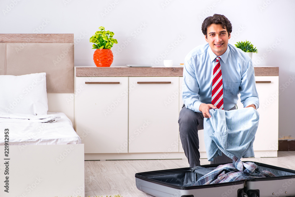 Young handsome businessman preparing for trip Young handsome businessman preparing for trip