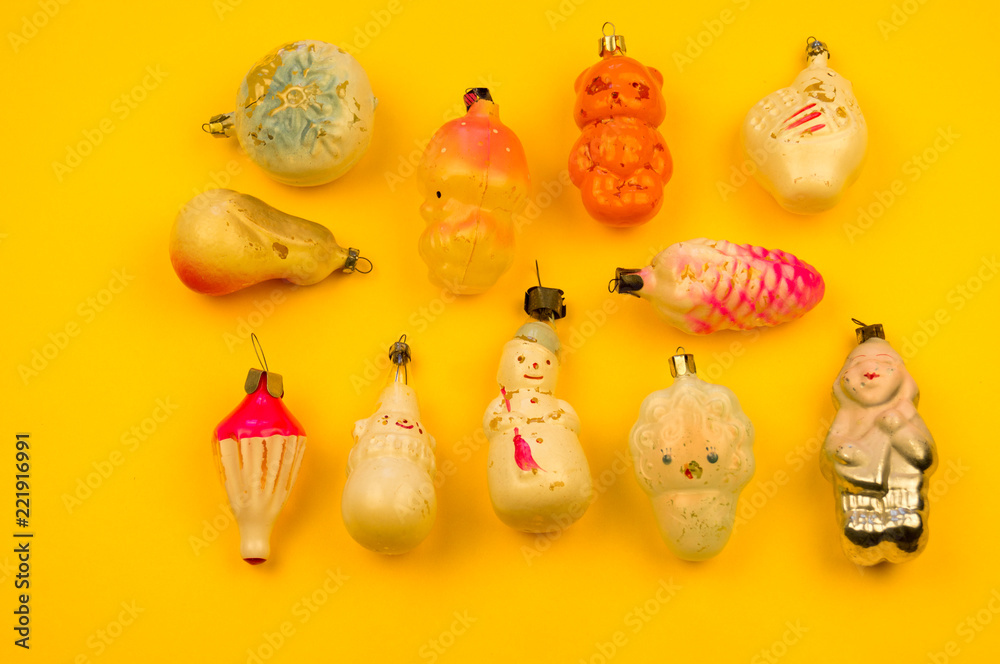 Old fur-tree toys on a yellow background