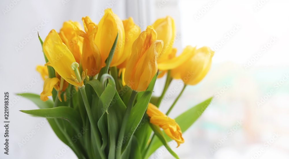 A bouquet of red tulips in a vase on the windowsill. A gift for A bouquet of red tulips in a vase on the windowsill. A gift for
