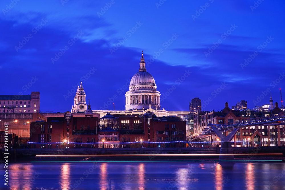 St. Paul's Cathedral Light up at Twilight with Millennium Bridge and Light Trail of Boat in Thames River