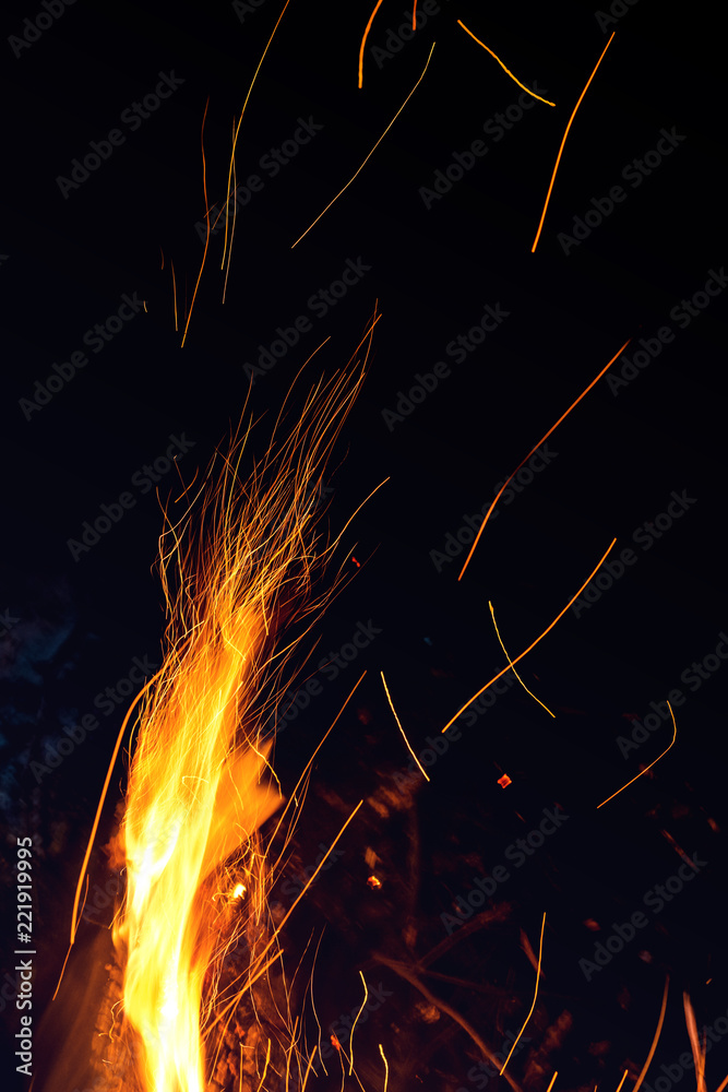 Night bonfire with sparks. Fire bright vertical background