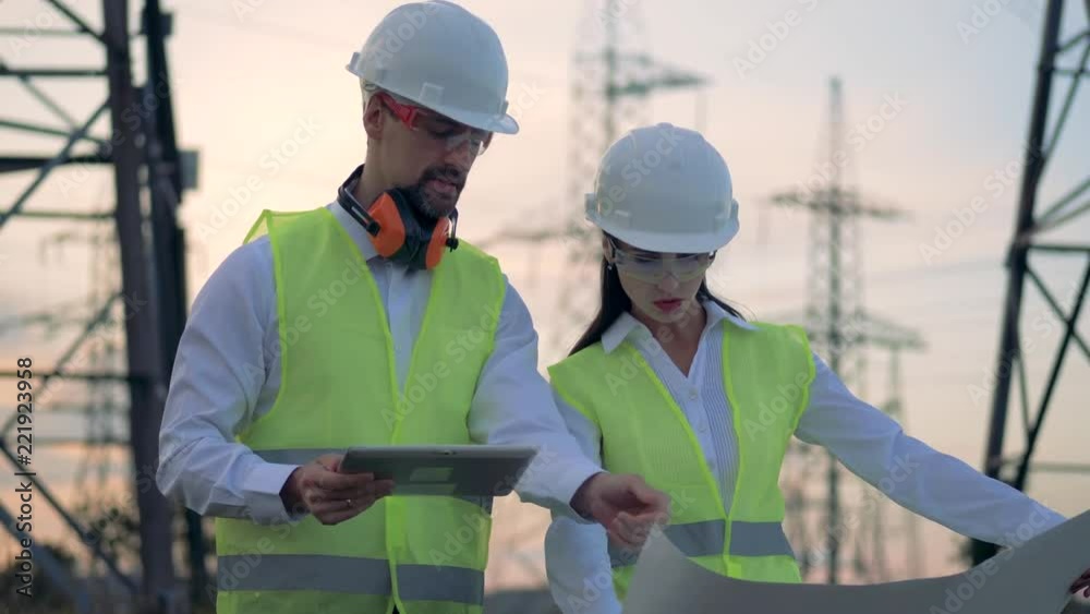 Electricians at a power line, close up. Electricians at a power line, close up.