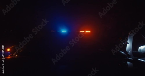 front view of police car from hood with lights on parked