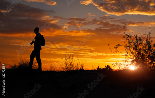Silhouette of photographer with his camera during sunset © es0lex