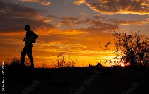 Silhouette of photographer with his camera during sunset