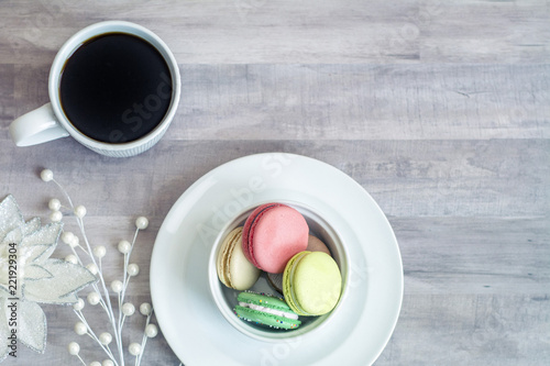 christmas macaroons in bowl with coffee cup