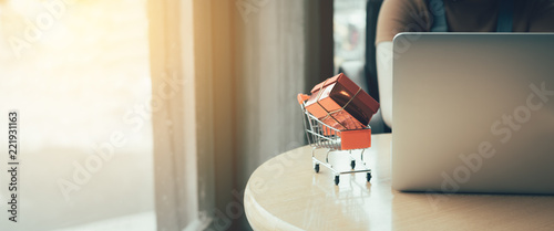 Shopping online concept with woman using laptop in cafe.