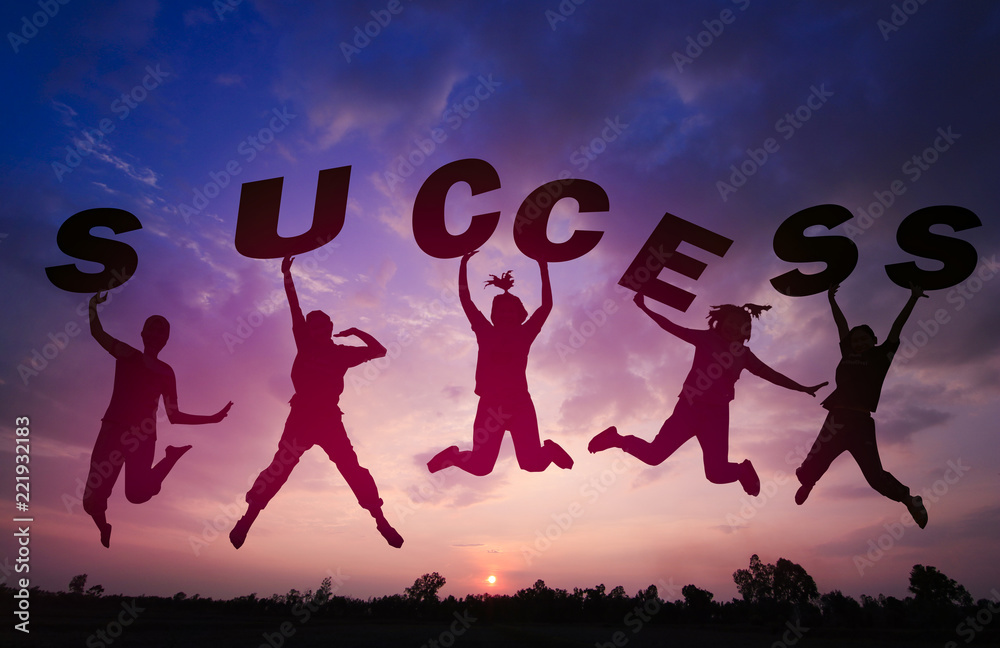 Silhouette sunset background and Team work .They are jumping in to sky and  lift success word. They are happy and fun for activity, out door,success,  Photo Silhouette and success concept idea. Stock