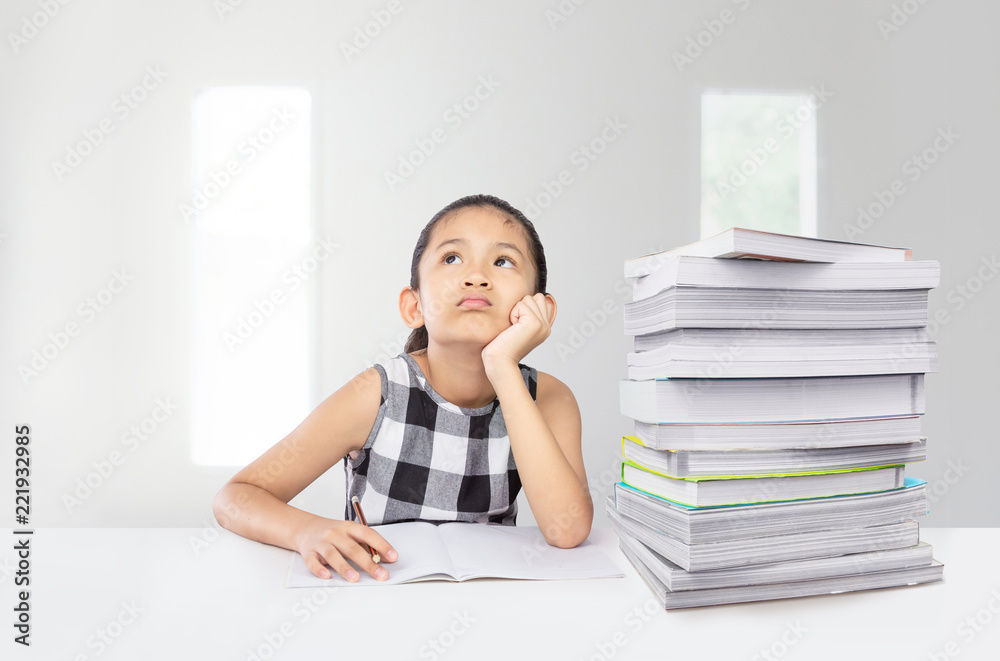 Cute asian girl tired on her study with huge stack of textbook on table a concept for unsuccessful education system Cute asian girl tired on her study with huge stack of textbook on table a concept for unsuccessful education system