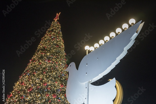 Decoratively decorated  for Christmas celebrations tree and pigeon with Chanukah Menorah on the Sderot Ben Gurion street in Haifa in Israel photo