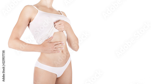 Muscular woman's body in lingerie isolated on white background.