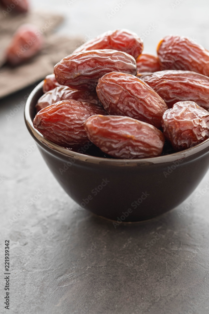 Fresh Medjool Dates in a bowl. Ramadan kareem. Black background. Top view. Copy space. Fresh Medjool Dates in a bowl. Ramadan kareem. Black background. Top view. Copy space.