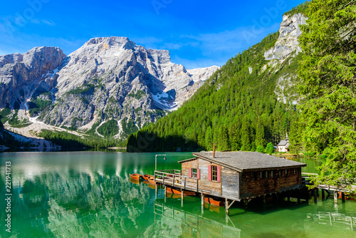 Lake Braies (also known as Pragser Wildsee or Lago di Braies) in Dolomites Mountains, Sudtirol, Italy. Romantic place with typical wooden boats on the alpine lake.  Hiking travel and adventure.  photo