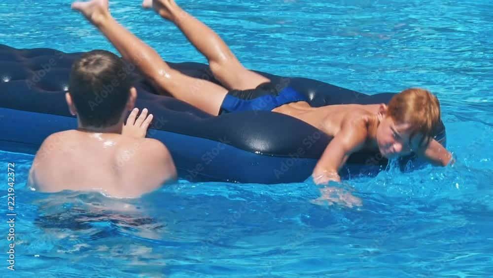 Two happy children near swimming pool