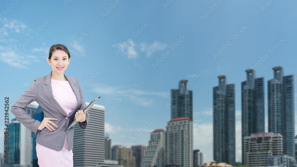 Mix image.Business woman holding smartphone in hand with background city view. Mix image.Business woman holding smartphone in hand with background city view.