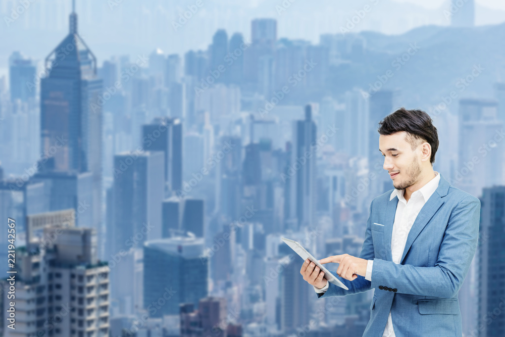 Mix image.Business man holding smartphone in hand with background city view. Mix image.Business man holding smartphone in hand with background city view.