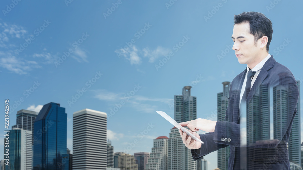 Mix image.Business man holding smartphone in hand with background city view. Mix image.Business man holding smartphone in hand with background city view.