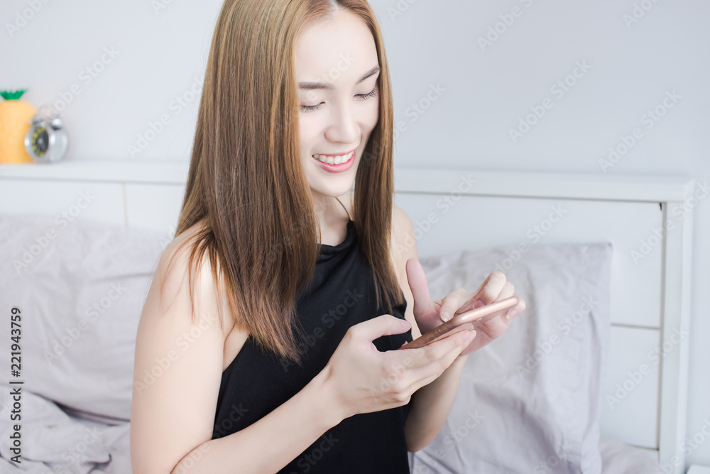 Asian business woman in black dress Laughing and touching a smartphone, beauty face, Asian business woman in black dress Laughing and touching a smartphone, beauty face,