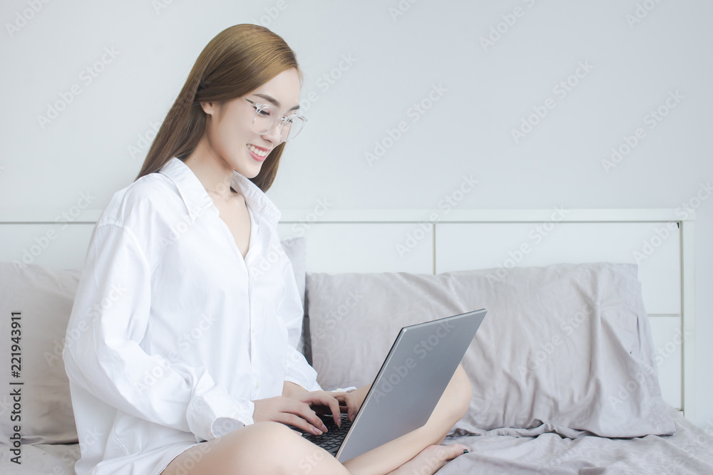 Beautiful Asian Woman use of laptop computer for working at home Beautiful Asian Woman use of laptop computer for working at home