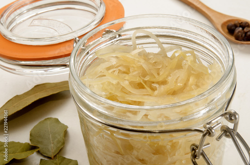 sauerkraut in a glass jar with bayleaf