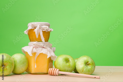 Fototapeta Naklejka Na Ścianę i Meble -  Jewish holiday Rosh Hashanah background with honey and apples on wooden table.
