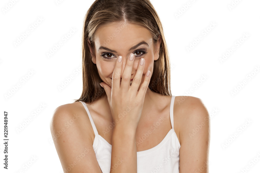 Portrait of young beautiful ashamed happy girl on white backgeound Portrait of young beautiful ashamed happy girl on white backgeound