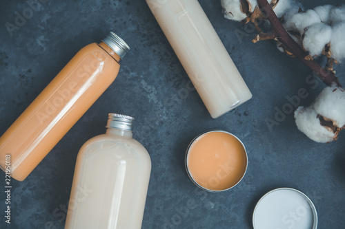 Natural spa cosmetics on a dark blue beton concrete background. Beauty blogger, minimalism concept, copy space