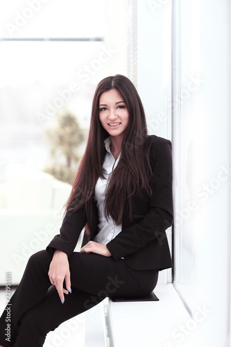 young employee sitting near a window in the office
