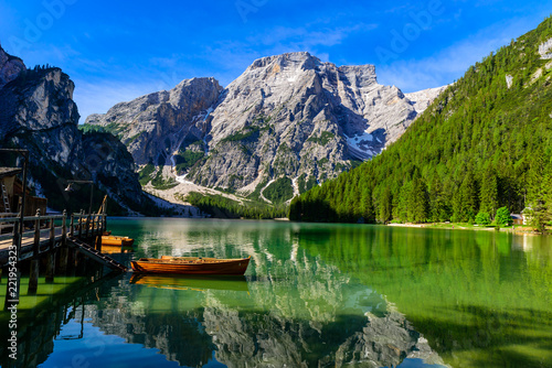 Lake Braies (also known as Pragser Wildsee or Lago di Braies) in Dolomites Mountains, Sudtirol, Italy. Romantic place with typical wooden boats on the alpine lake.  Hiking travel and adventure. photo