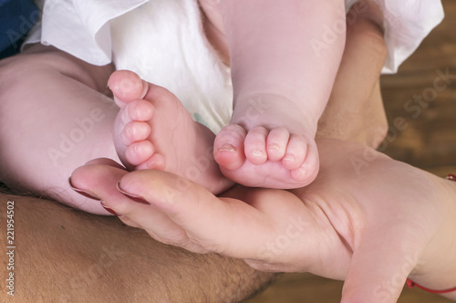 Mother and Father´s Hand Holding Baby´s Legs