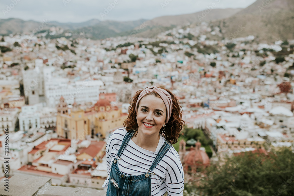 Fototapeta premium Beautiful view of the Mexican city of Guanajuato. Aerial view with a european tourist. Lifestyle portrait.