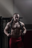 portrait of a handsome male bodybuilder with a chain around his neck