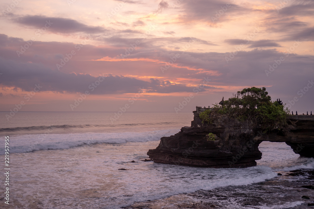 Sunset at Pura Batu Bolong temple on the beatiful rock in Bali