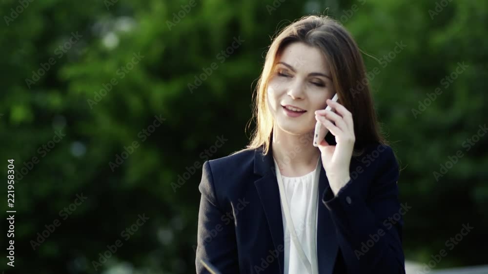 A young businesswoman with smartphone outdoors, making a phone call. A young businesswoman with smartphone outdoors, making a phone call.