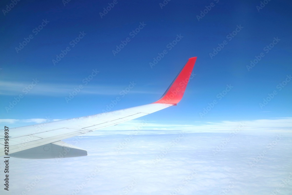 Beautiful view from airplane's window with airplane's wing, blue sky and white cloud in the summer morning. Soft focus. Beautiful view from airplane's window with airplane's wing, blue sky and white cloud in the summer morning. Soft focus.