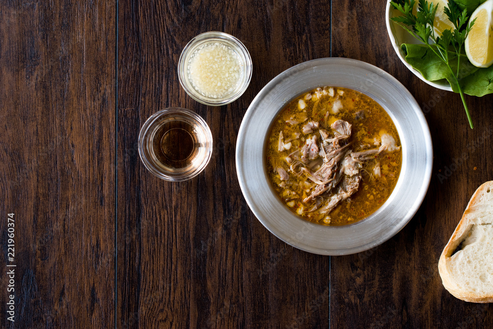 Turkish Soup Beyran with Lamb Meat, Rice, Chopped Garlic and Vinegar Sauce Served with Salad. Turkish Soup Beyran with Lamb Meat, Rice, Chopped Garlic and Vinegar Sauce Served with Salad.