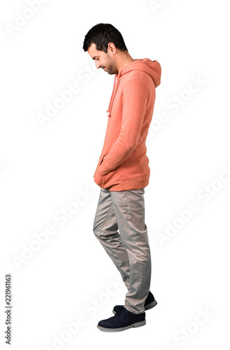 Full body of  Man in a pink sweatshirt standing and looking down on isolated white background. Ideal for use in architectural designs