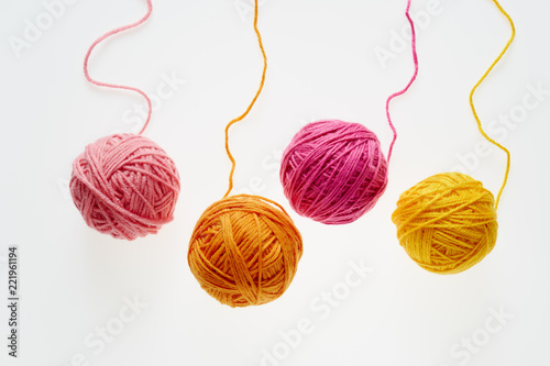 Fototapeta Collection of colorful woolen balls, partially unrolled.