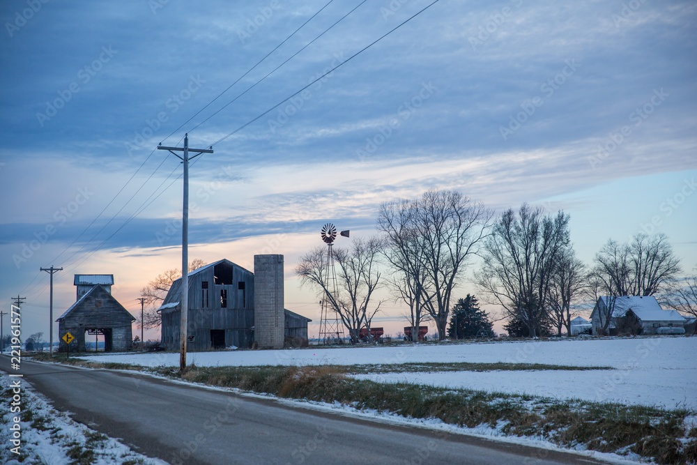 Fototapeta premium Cloudy Winter Dusky Sky over Old Derelict Farm and Windmill.