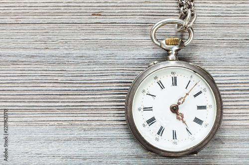 retro pocket watch on gray wooden table