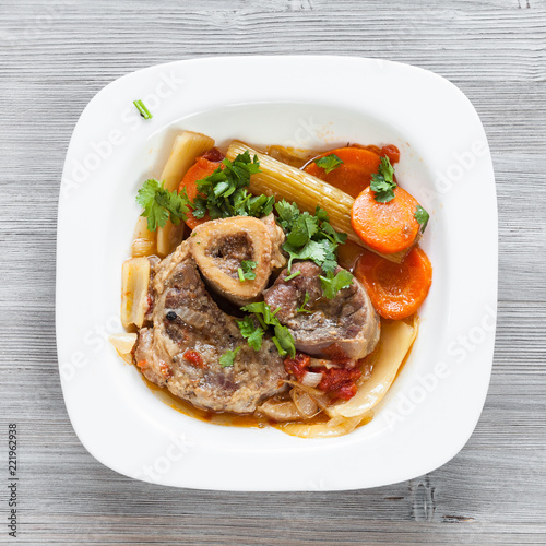 top view of italian dish Ossobuco on gray board